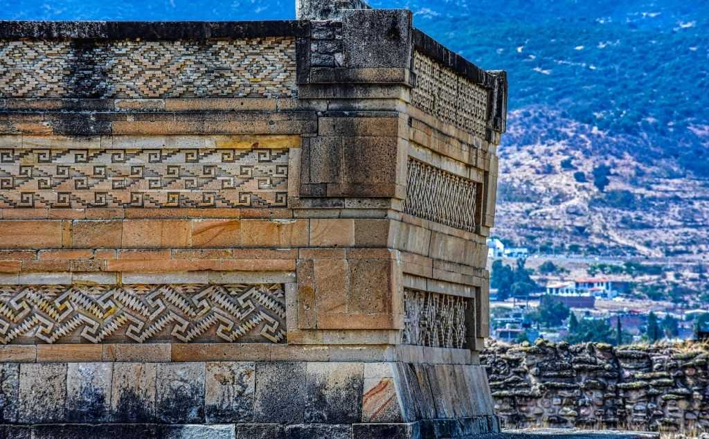 a stone building with a city in the background