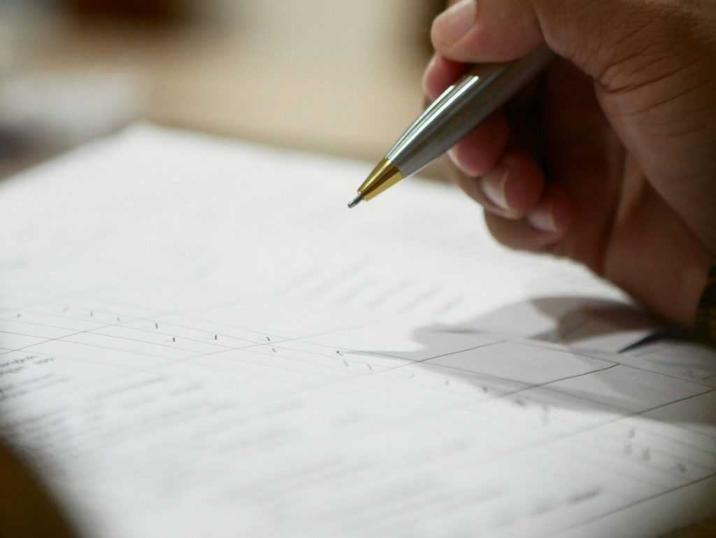 a hand holding a pen